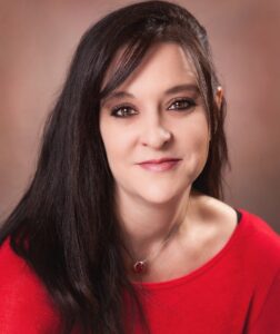 Woman in red top smiling at camera