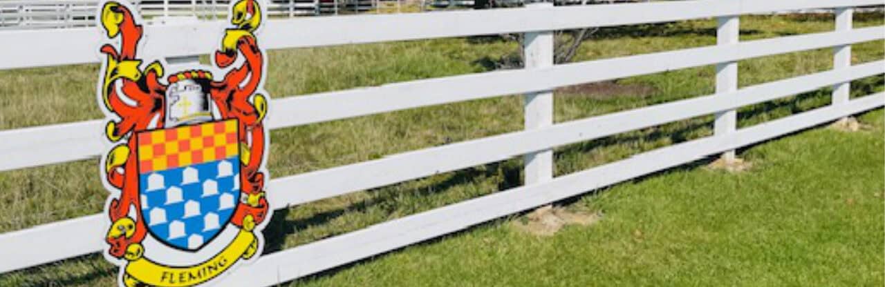 Colorful coat of arms on white fence