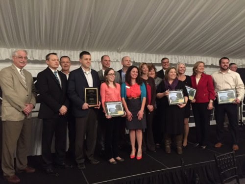 Group of professionals receiving awards at a formal event